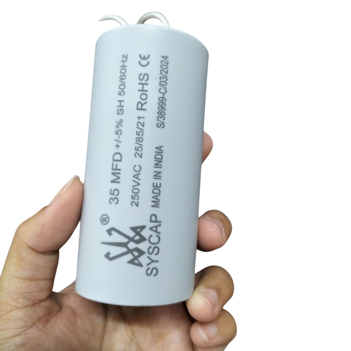 Syscap 35MFD Motor Running Capacitor held in hand for electrical circuitry and parts