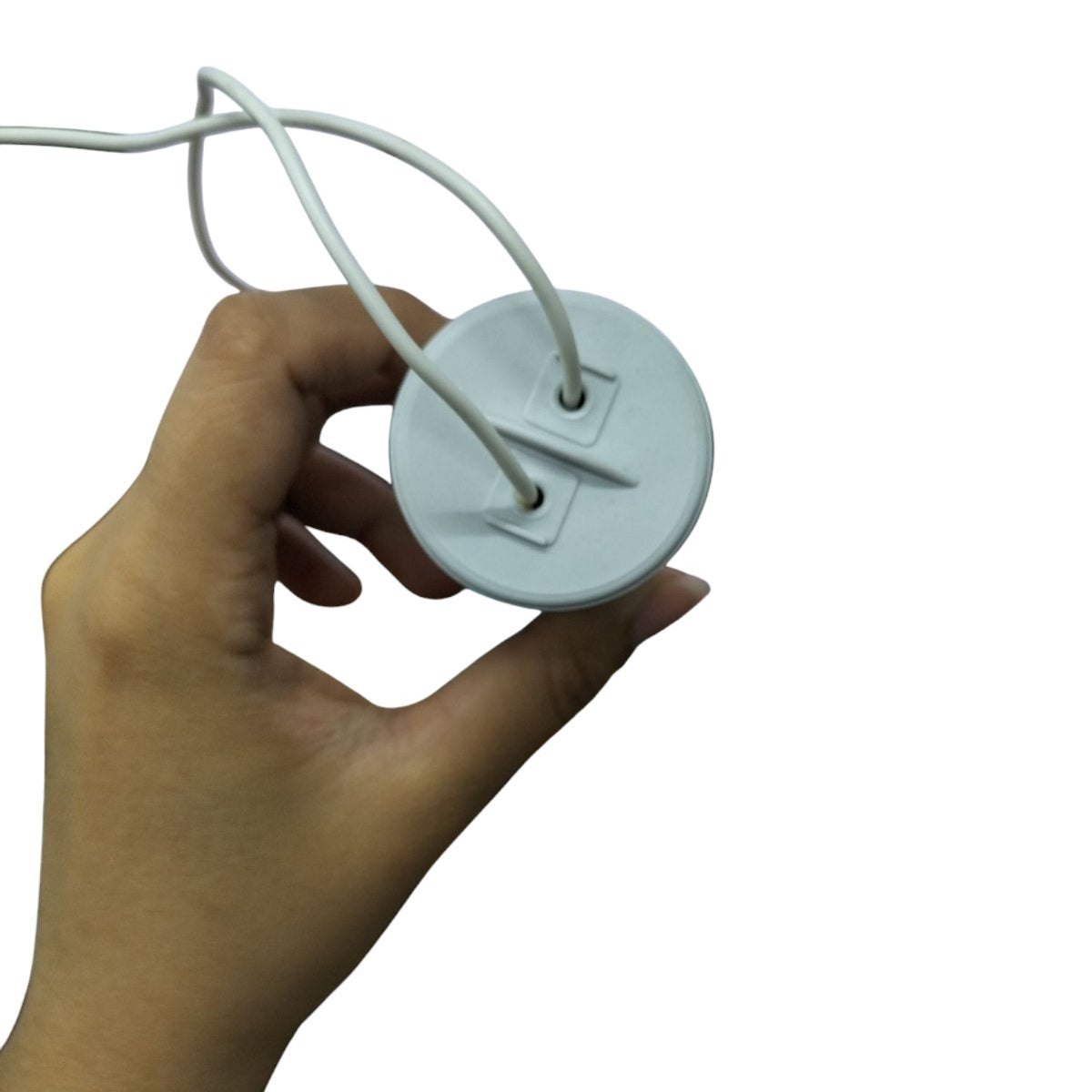 Hand holding Syscap 35MFD Motor Running Capacitor with two white wires for electrical circuitry