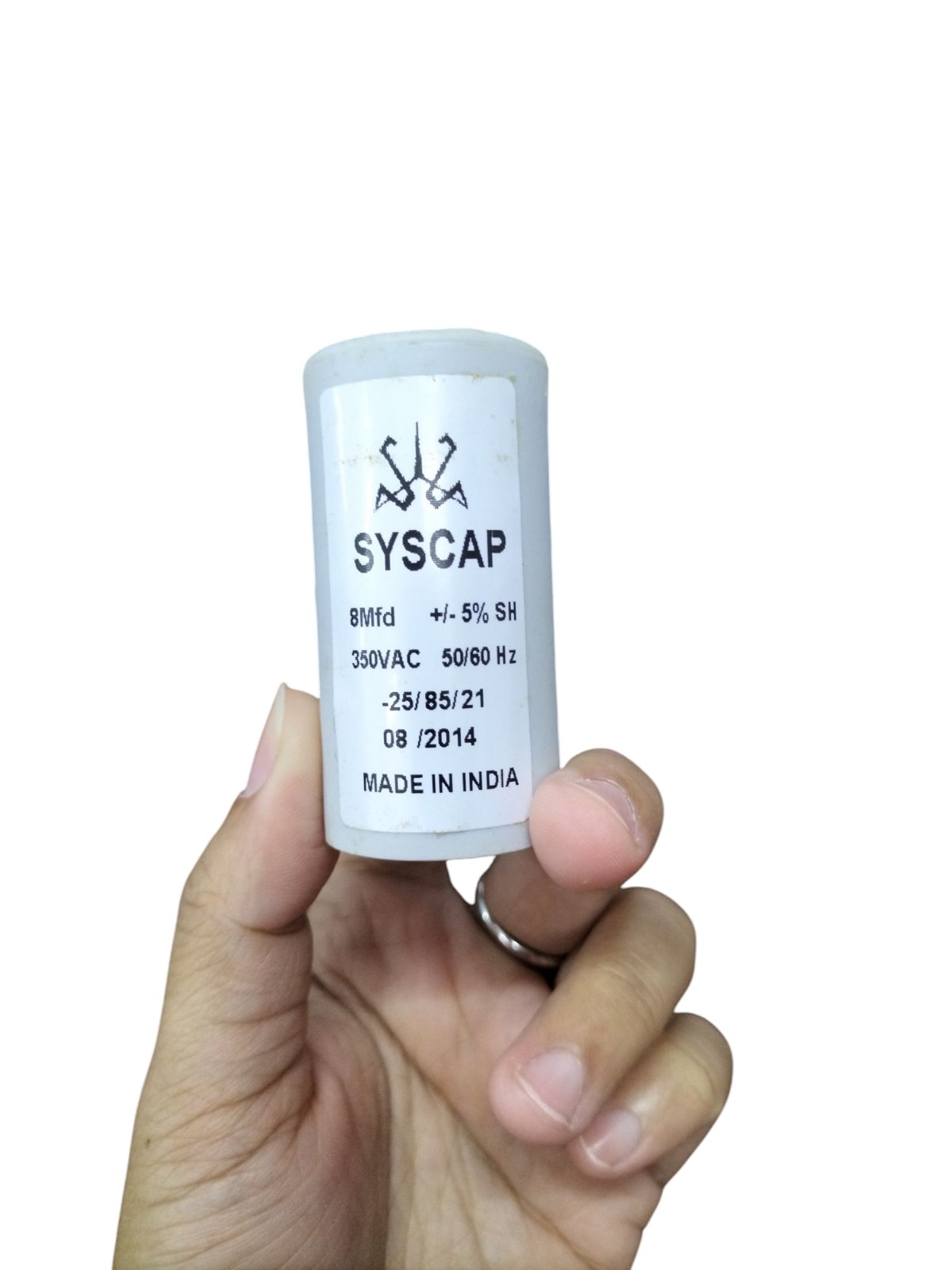 Syscap 8 Microfarad Motor Run Capacitor in a hand, rated 350VAC for reliable motor operation