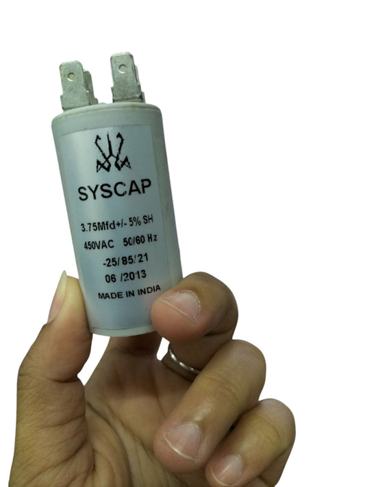 Person holding SYSCAP motor capacitor 450V AC with specifications clearly visible on the body