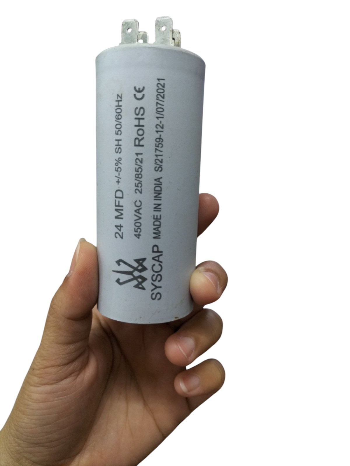 Syscap motor running capacitor 24MFD held in hand for electrical circuitry use