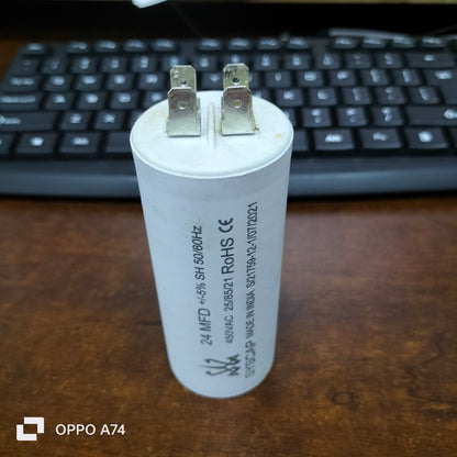 Syscap motor running capacitor 24MFD white cylindrical electrical component on wooden desk