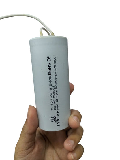 Syscap Motor Running Capacitor 33MFD electrical component held in hand for motor applications