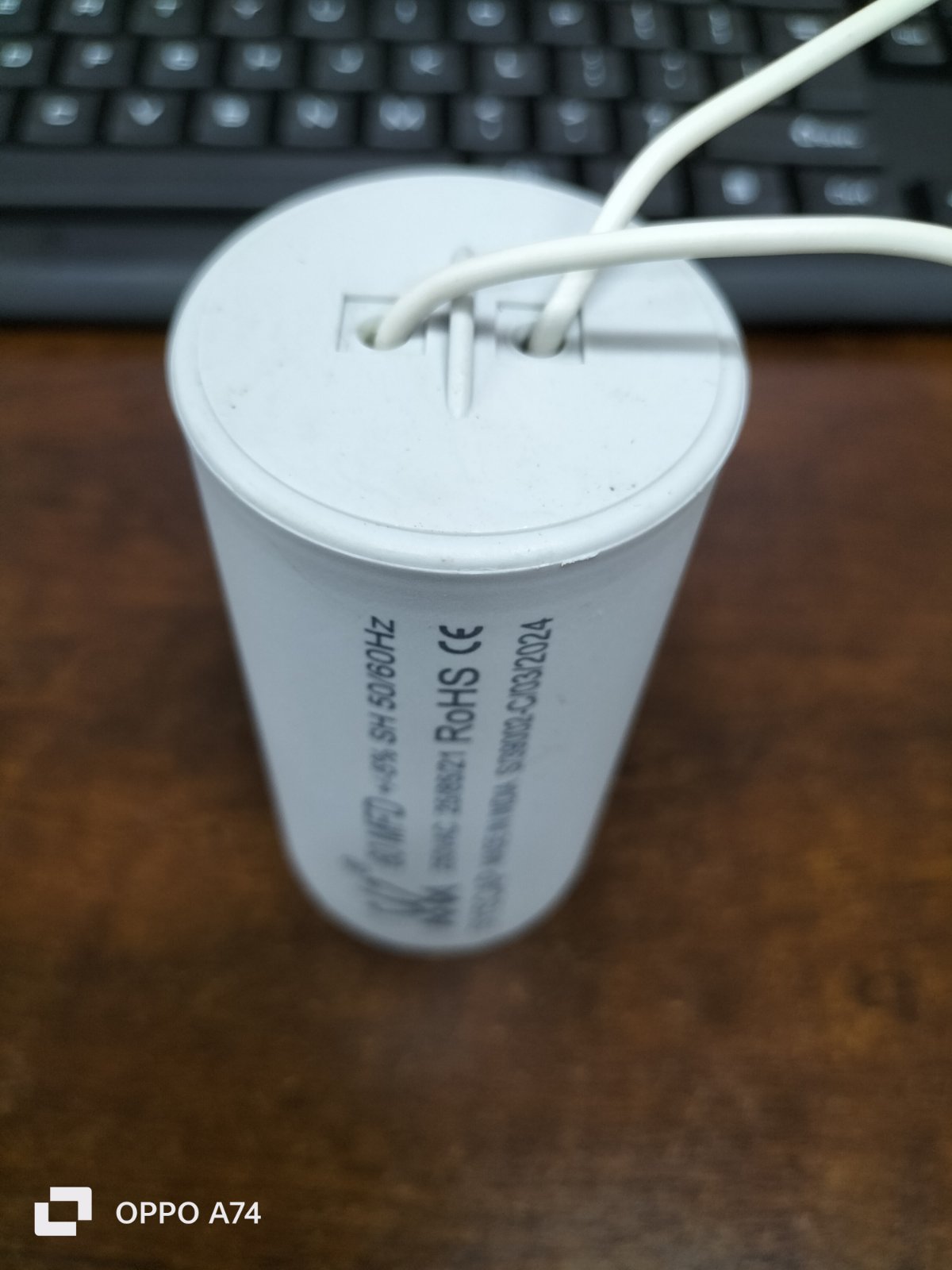 Syscap motor running capacitor 60MFD 250V featuring a cylindrical design with wire connectors