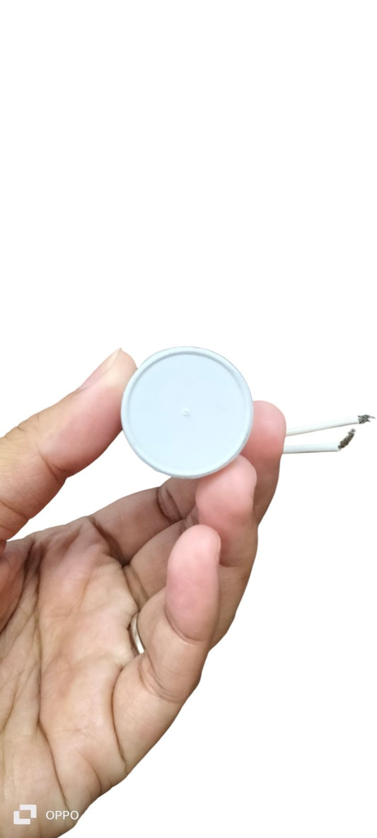 Syscap motor running capacitor 7uF 350V held in hand, showcasing its compact design