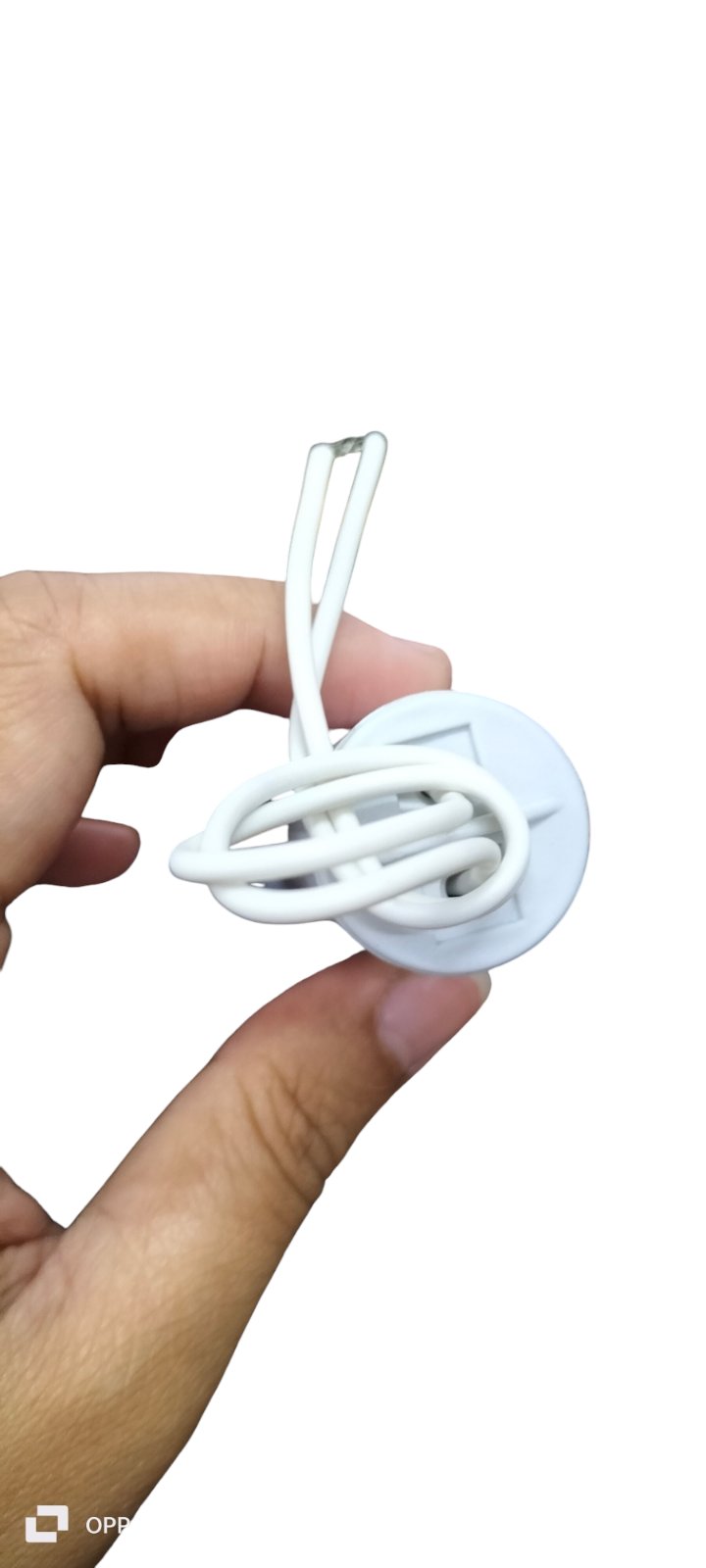 Hand holding a motor running capacitor 7uF 350V with wiring for electrical circuit applications