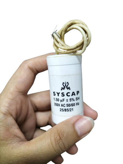 Hand holding Syscap Running Capacitor 1.5MFD 350 VAC white cylindrical motor capacitor with lead wires
