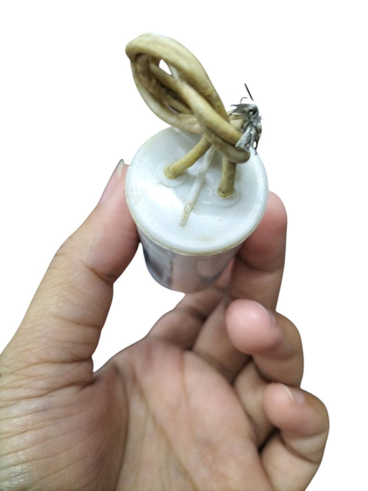 Syscap Running Capacitor 1.5MFD 350 VAC cylindrical motor capacitor with white plastic top and looped wires in hand