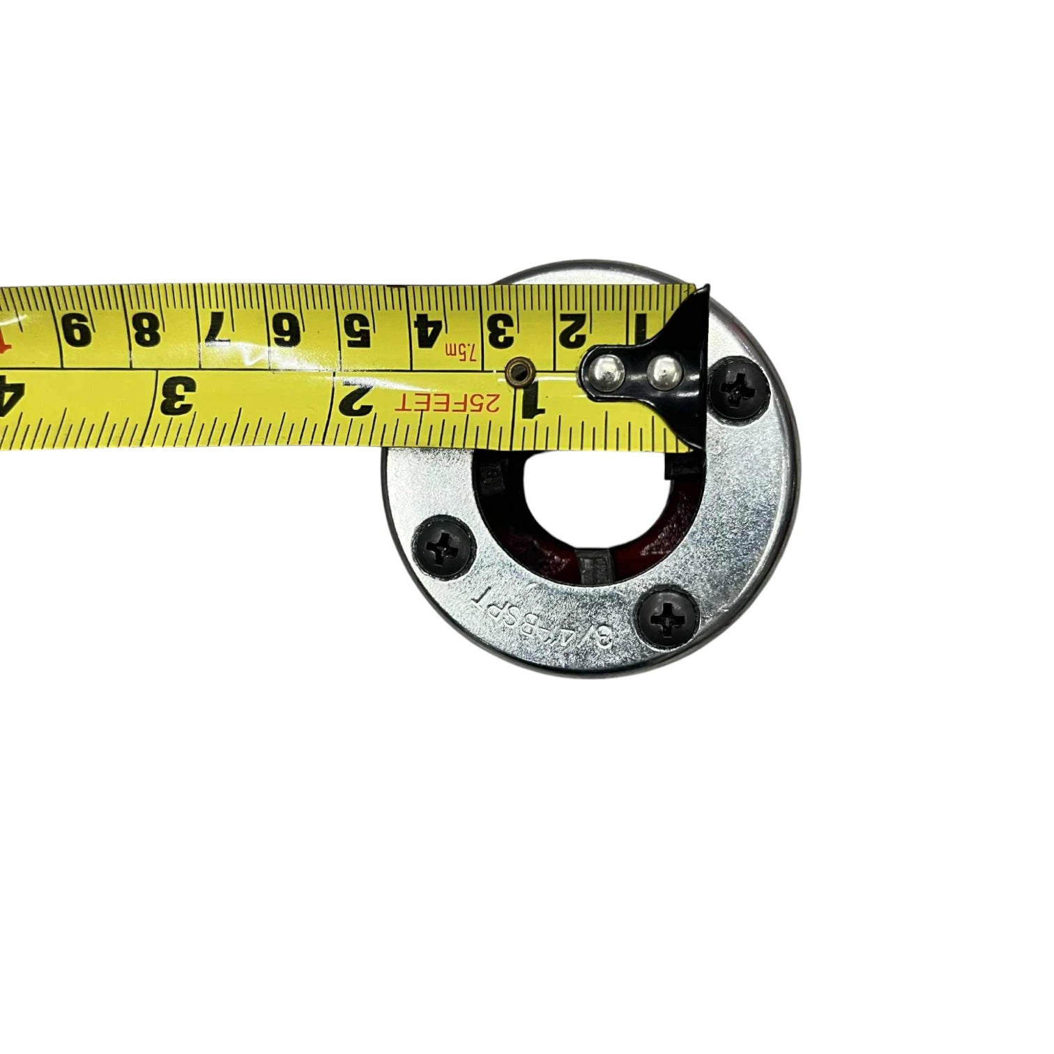 Close up of ratchet pipe threader set round metal die head with measuring tape showing two inch diameter