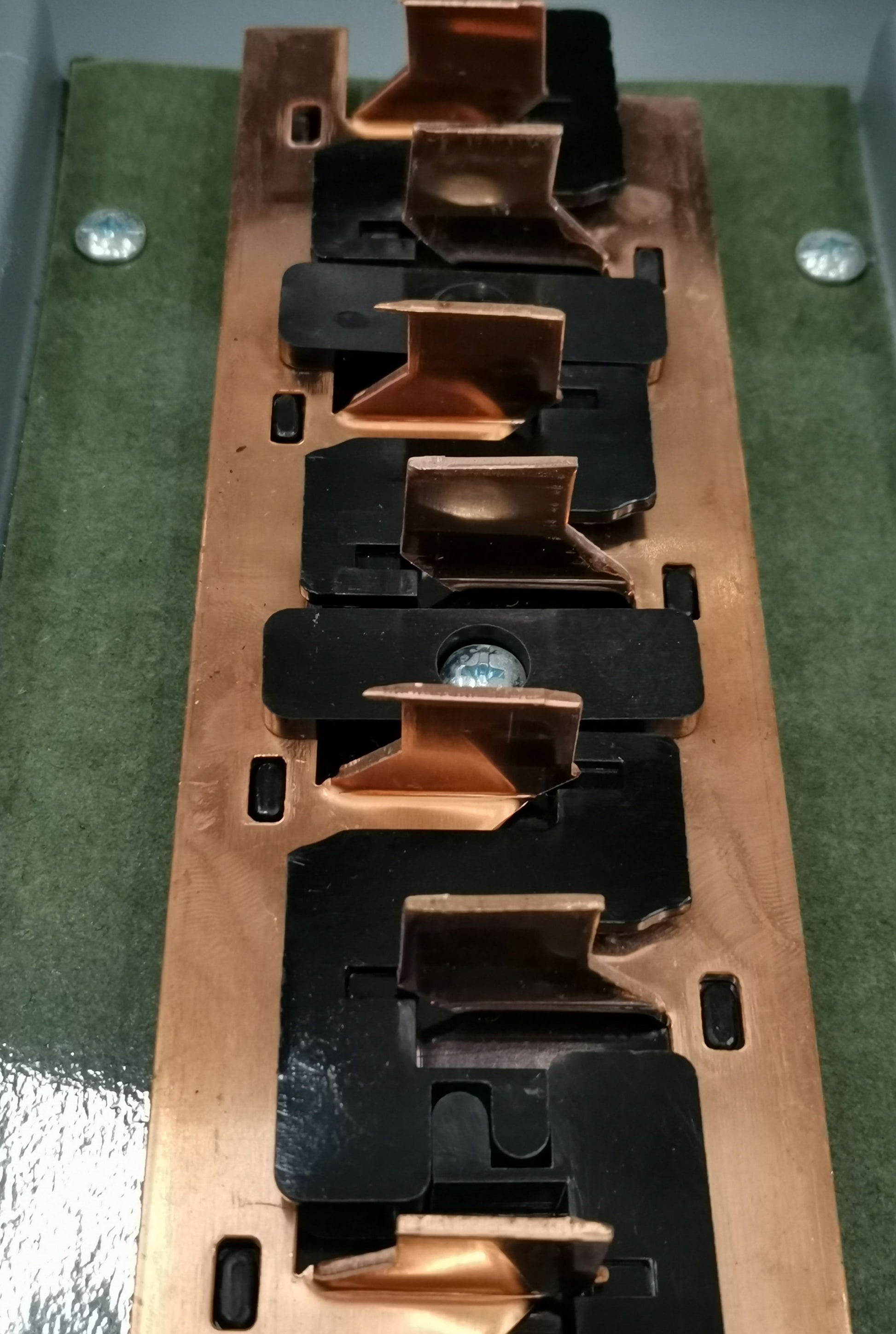 Close-up of America electrical circuitry showing copper connectors in 4x4 panel board TQL