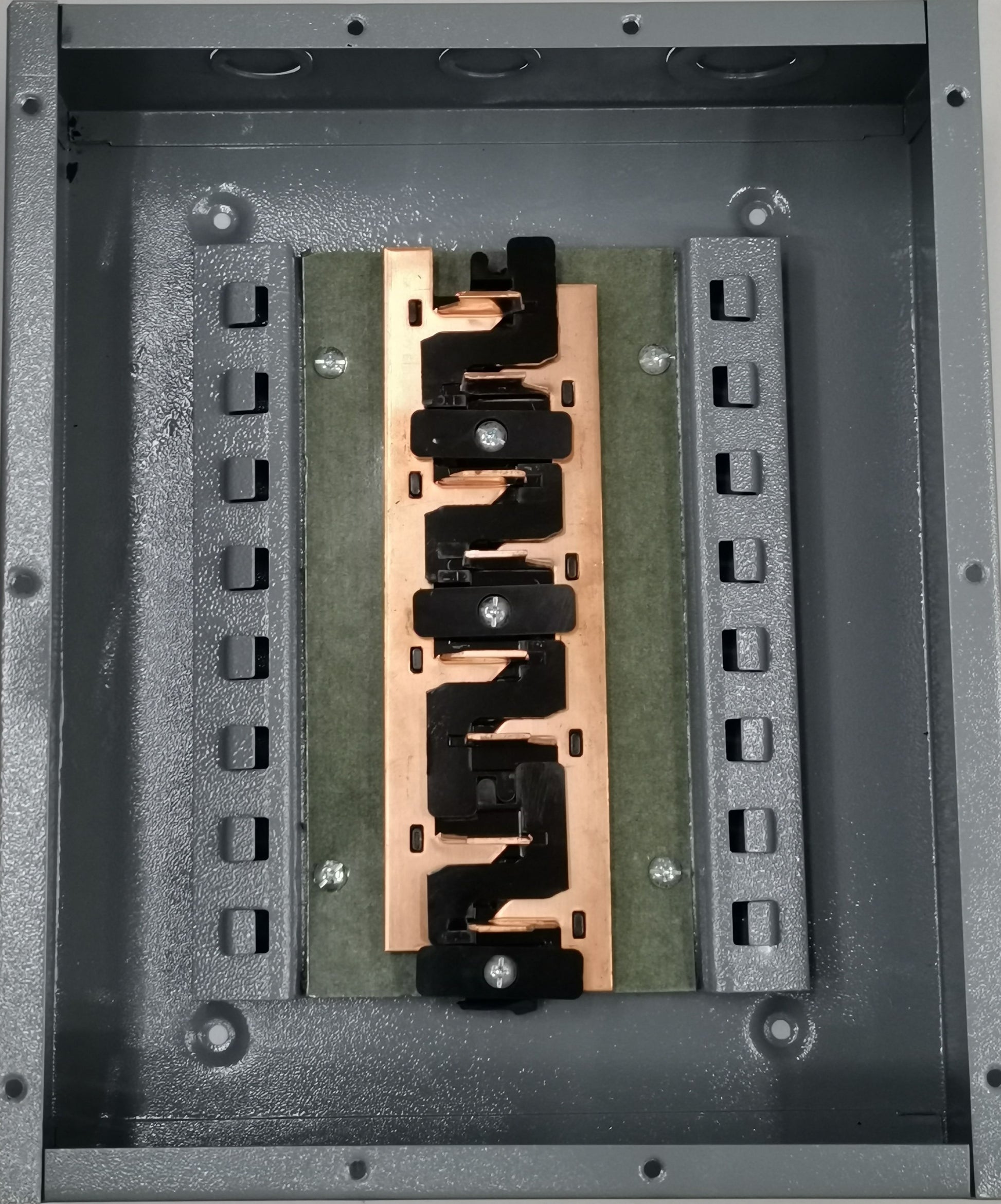 4x4 panel board TQL electrical circuitry part with copper bus bar and black connectors inside gray metal enclosure