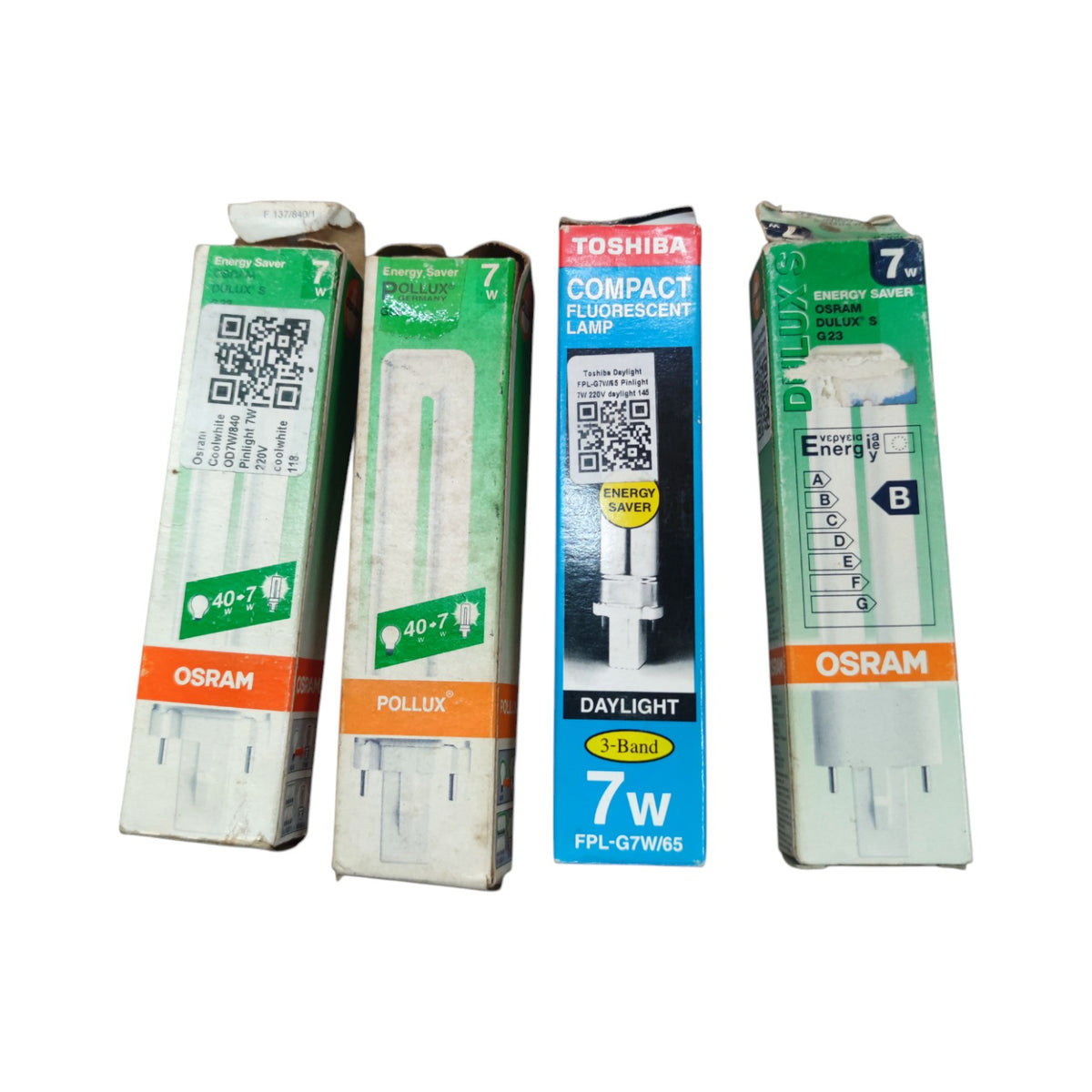 Four boxed fluorescent replacement lamps arranged side by side on a plain white background. Visible brands include Osram on two boxes, Pollux on one box, and Toshiba on one box.