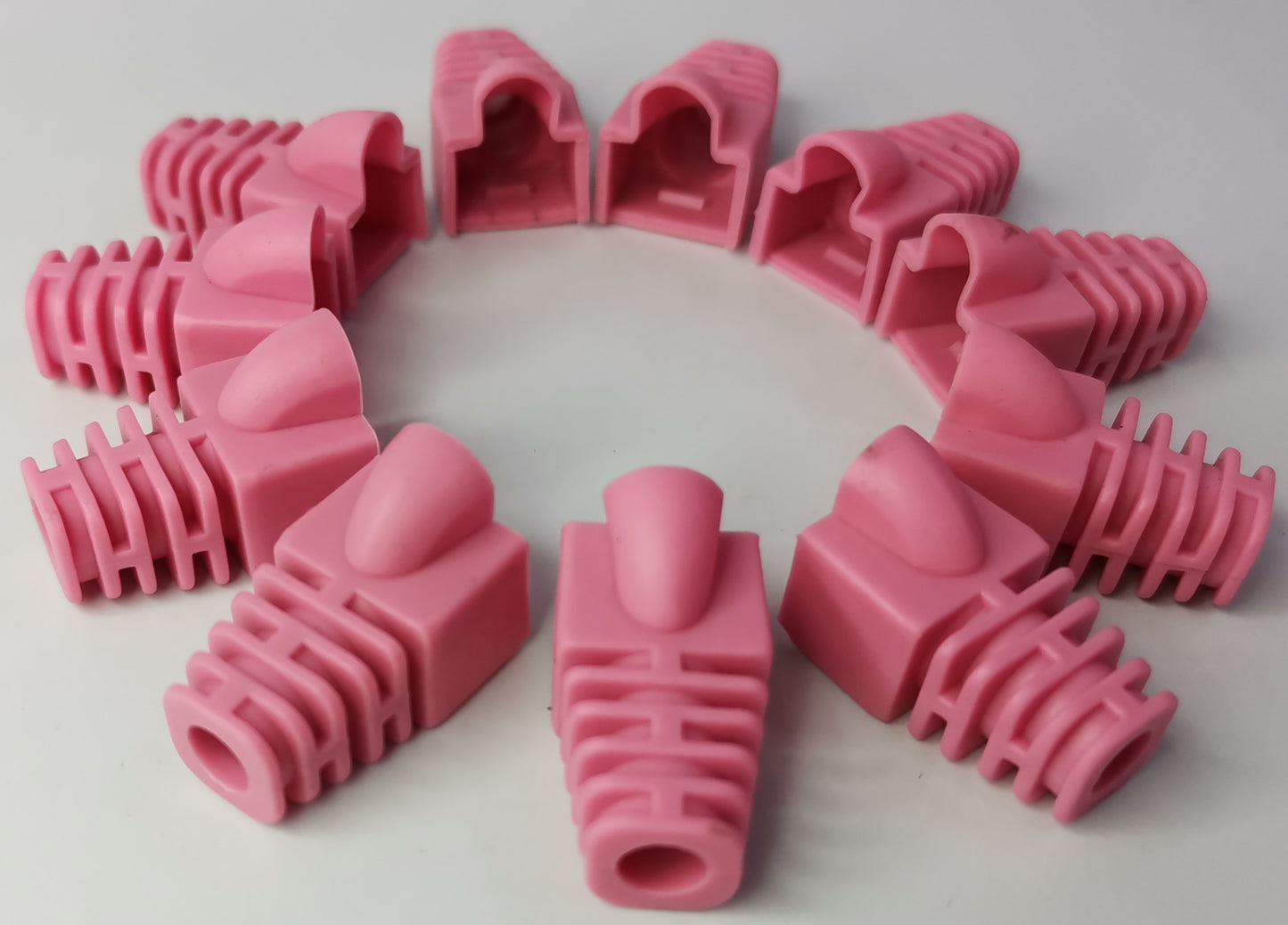 Pink Rubber BooT RJ45 Grippes arranged in a circle for cable protection and strain relief