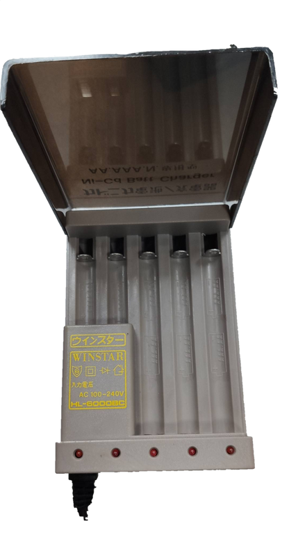 Ni-Cd battery charger for AA and AAA batteries with transparent lid and four charging slots